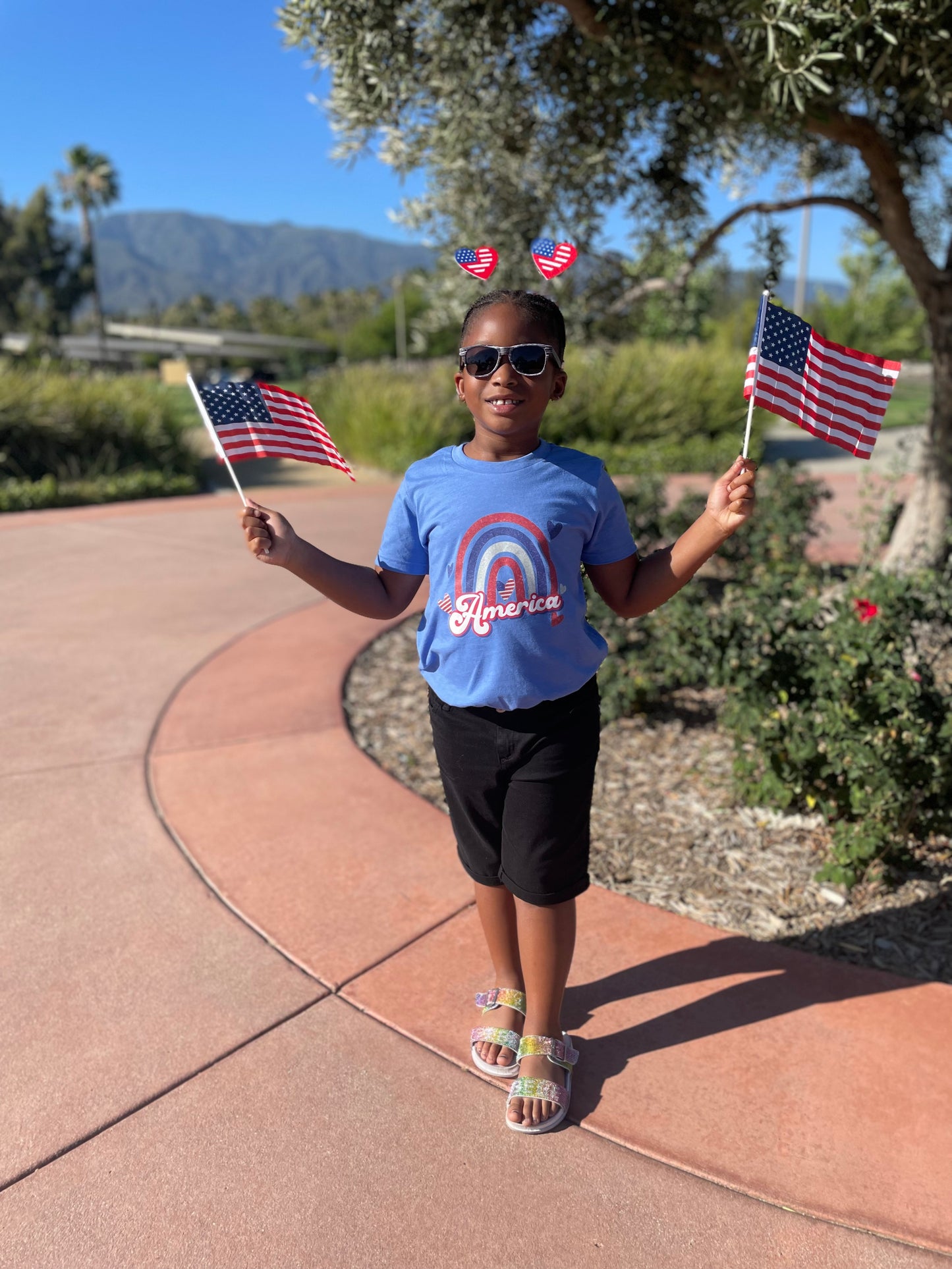 blue shirt with rainbow in red white blue with America below the rainbow